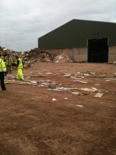 Pickers inspect and sort through waste wood and plasterboard at the Exeter branch of Wood Yew Waste